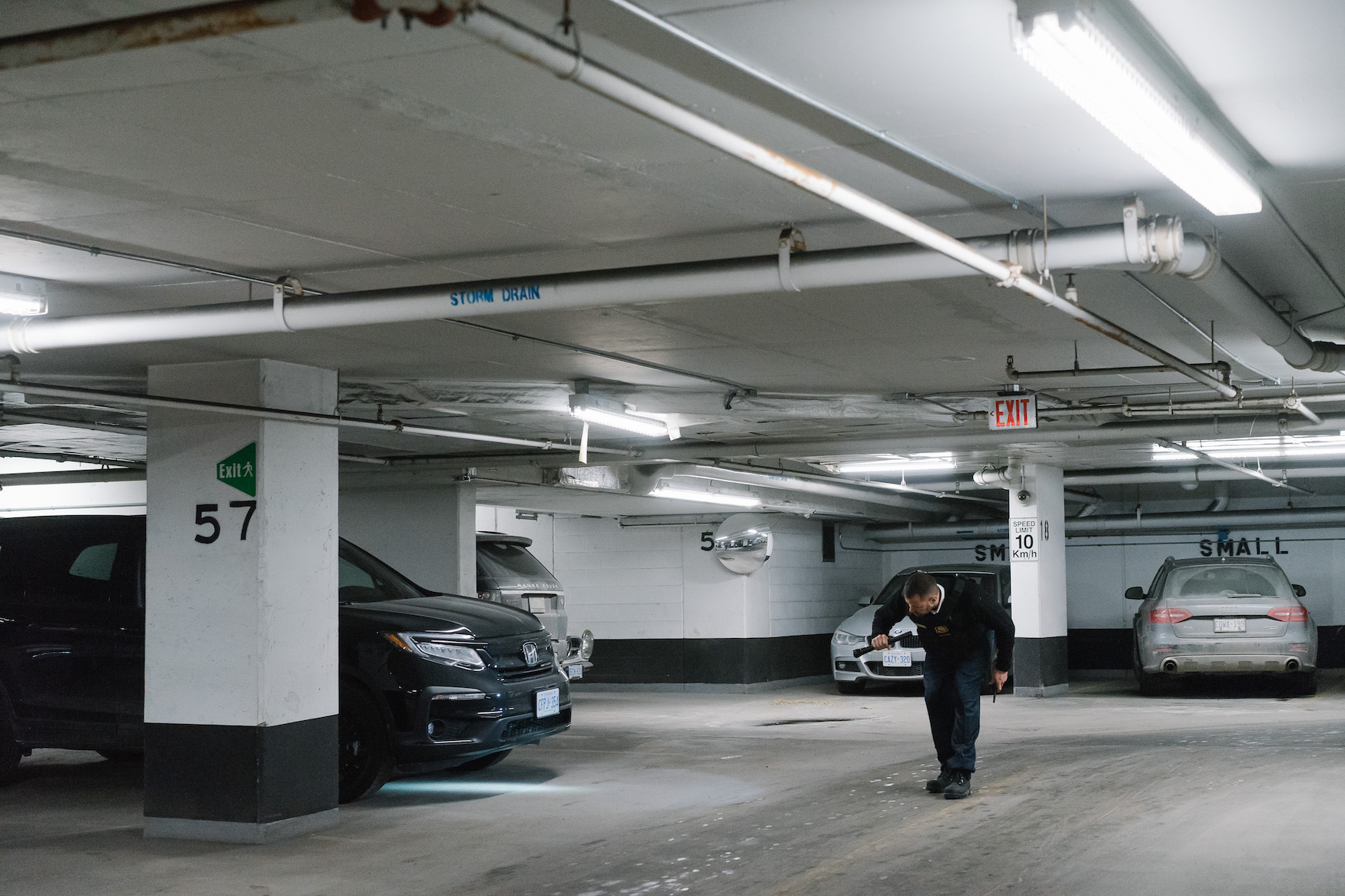 Concierge guard inspecting underground parking
